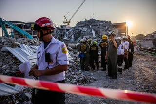 Thai rescue teams provide aid at a construction building collapse